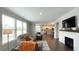 Spacious living room with fireplace, hardwood floors, modern lighting, neutral decor, and natural light from windows at 17303 Lillian St, Westfield, IN 46074