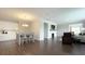 Open-concept living area featuring a fireplace, hardwood floors, modern lighting, and neutral decor at 17303 Lillian St, Westfield, IN 46074