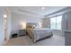 Relaxing main bedroom featuring a tray ceiling, carpet, soft lighting, and an ensuite bathroom at 17303 Lillian St, Westfield, IN 46074