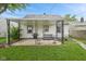 Exterior view of backyard with covered patio, grill, and swing bench at 1739 Caldwell Pl, Columbus, IN 47201