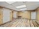 Unfinished basement area with updated flooring, doors, and a window at 1739 Caldwell Pl, Columbus, IN 47201