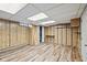 Unfinished basement features wood-look flooring and paneled walls at 1739 Caldwell Pl, Columbus, IN 47201