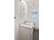 Bathroom featuring white vanity, mosaic patterned wallpaper, and natural light at 1739 Caldwell Pl, Columbus, IN 47201