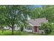 Delightful home featuring well-maintained landscaping, a cozy porch, and a bright red front door at 1739 Caldwell Pl, Columbus, IN 47201