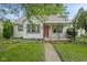 Charming home featuring a well-manicured lawn, inviting walkway, and a cozy front porch with red door at 1739 Caldwell Pl, Columbus, IN 47201