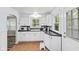Cozy kitchen featuring white cabinets, black counters, and a view to the adjacent room at 1739 Caldwell Pl, Columbus, IN 47201