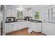 Charming kitchen boasts white cabinets, black counters, and ample natural light at 1739 Caldwell Pl, Columbus, IN 47201