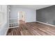 Spacious living room featuring stylish wood floors, neutral walls, and archway at 1739 Caldwell Pl, Columbus, IN 47201