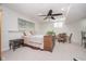 Well-lit basement bedroom with a cozy bed, a ceiling fan, and comfortable furniture at 18432 Oriental Oak Ct, Noblesville, IN 46062