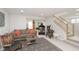 Spacious finished basement featuring a sofa, decorative rug, and convenient access to the staircase at 18432 Oriental Oak Ct, Noblesville, IN 46062