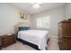 Cozy bedroom features carpet, lots of natural light, and a traditional dresser with dark wood finish at 18432 Oriental Oak Ct, Noblesville, IN 46062