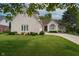 Charming brick home featuring a well-manicured lawn, curved driveway, and lush landscaping at 18432 Oriental Oak Ct, Noblesville, IN 46062