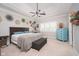 Inviting bedroom with a tray ceiling, carpet floors, and a decorative dresser with a blue finish at 18432 Oriental Oak Ct, Noblesville, IN 46062