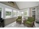 Relaxing sunroom with lots of windows, two comfortable chairs, and a decorative fish on the wall at 18432 Oriental Oak Ct, Noblesville, IN 46062