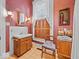 Bathroom features a patterned wallpaper, classic fixtures, including a sink and vintage-style sconce lighting at 228 W Washington St, Shelbyville, IN 46176