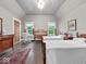 Spacious bedroom with hardwood floors, two beds, and bright windows, blending comfort and natural light at 228 W Washington St, Shelbyville, IN 46176