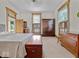 Spacious bedroom with neutral carpet, complemented by wood-framed windows and antique wood furniture at 228 W Washington St, Shelbyville, IN 46176