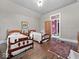 Bedroom featuring two beds, hardwood floors, and bright windows, creating a tranquil and inviting space at 228 W Washington St, Shelbyville, IN 46176