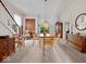 Bright dining room featuring a round table, staircase, and hutch, with glass doors leading to the exterior at 228 W Washington St, Shelbyville, IN 46176