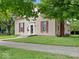 Side view of a two-story home with a well-manicured lawn and red brick chimney on a sunny day at 228 W Washington St, Shelbyville, IN 46176
