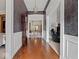 Inviting hallway showcasing hardwood floors and decorative wallpaper leading to adjacent rooms at 228 W Washington St, Shelbyville, IN 46176