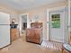 Vintage kitchen boasts unique copper oven, light wallpaper, and seamless transition to nearby dining area at 228 W Washington St, Shelbyville, IN 46176