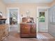 Vintage kitchen boasts unique copper oven, light wallpaper, and seamless transition to nearby dining area at 228 W Washington St, Shelbyville, IN 46176