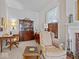 Cozy living room features a wingback chair, fireplace, and built-in bookcase with natural light from the window at 228 W Washington St, Shelbyville, IN 46176