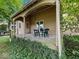 Inviting covered porch with outdoor seating, perfect for relaxing and enjoying the surrounding greenery at 228 W Washington St, Shelbyville, IN 46176
