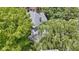 Aerial view featuring landscaped yard and a welcoming front porch, nestled among mature trees and greenery in desirable neighborhood at 23 S Downey Ave, Indianapolis, IN 46219