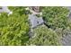 Aerial view of house featuring a cozy front porch, surrounded by mature trees and greenery in a desirable neighborhood at 23 S Downey Ave, Indianapolis, IN 46219