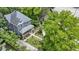 Aerial view of a charming home featuring landscaped yard and a welcoming front porch, nestled among mature trees and greenery at 23 S Downey Ave, Indianapolis, IN 46219