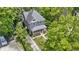 Aerial view showcases a charming gray home nestled among mature trees in a serene neighborhood setting at 23 S Downey Ave, Indianapolis, IN 46219