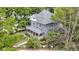 Aerial view of the two-story home showcasing the roof, porch, landscaped yard, and surrounding trees at 23 S Downey Ave, Indianapolis, IN 46219