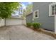 Backyard featuring a detached garage and lush green bushes at 23 S Downey Ave, Indianapolis, IN 46219