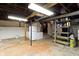 Basement with storage shelves, appliances, and unfinished ceiling at 23 S Downey Ave, Indianapolis, IN 46219