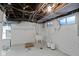 Unfinished basement with white-painted walls, utility sink, and window at 23 S Downey Ave, Indianapolis, IN 46219