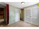 Light-filled room featuring two closets, green walls, and a view into other parts of the house at 23 S Downey Ave, Indianapolis, IN 46219