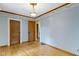 Simple bedroom offering wood floors and multiple doors for easy access at 23 S Downey Ave, Indianapolis, IN 46219