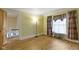 Bedroom with hardwood floors, neutral yellow walls, crown molding, and patterned curtains offers classic charm at 23 S Downey Ave, Indianapolis, IN 46219