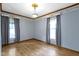 Cozy bedroom featuring pastel blue walls, wood floors, and bright natural light at 23 S Downey Ave, Indianapolis, IN 46219