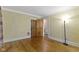 Bedroom featuring hardwood floors, neutral walls, crown molding, and interior access at 23 S Downey Ave, Indianapolis, IN 46219
