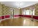 Formal dining room featuring hardwood floors, chandelier, and vintage floral wallpaper at 23 S Downey Ave, Indianapolis, IN 46219