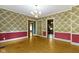 Dining room showcases floral wallpaper, classic chandelier, and multiple entry points at 23 S Downey Ave, Indianapolis, IN 46219