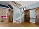 Foyer featuring hardwood floors, a staircase, and access to multiple rooms at 23 S Downey Ave, Indianapolis, IN 46219