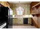 Functional kitchen with black appliances and ample cabinet space for storage at 23 S Downey Ave, Indianapolis, IN 46219
