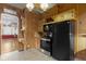 Traditional kitchen featuring knotty pine cabinets, wood paneling, and vintage appliances at 23 S Downey Ave, Indianapolis, IN 46219