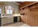 Traditional kitchen features wood paneling, updated appliances, and natural light at 23 S Downey Ave, Indianapolis, IN 46219