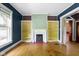 Bright living room boasts built-in shelves, fireplace, and decorative molding at 23 S Downey Ave, Indianapolis, IN 46219