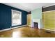 Bright living room featuring a fireplace, built-in bookshelves, and hardwood floors at 23 S Downey Ave, Indianapolis, IN 46219